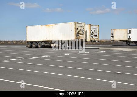 Cargo containers in truck trailers in a parking lot in Iceland Stock Photo