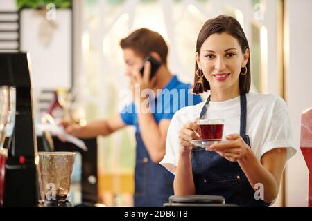 Female barista with fresh coffee Stock Photo