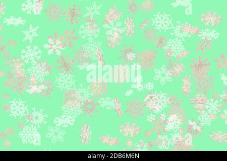 Beautiful snowflake pattern white and gold falling on a subtle pastel green background Stock Photo