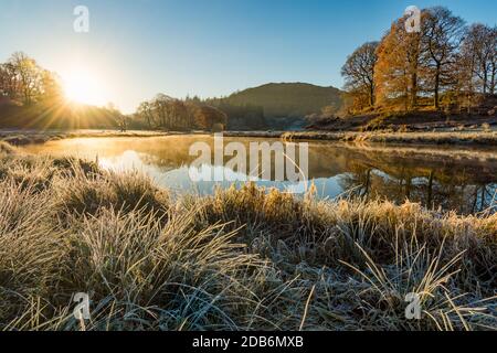 Sunrise on a cold frosty Autumn morning at River Brathay in the English Lake District. Stock Photo