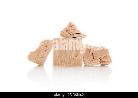 Fresh pressed yeast blocks isolated on white background. Stock Photo