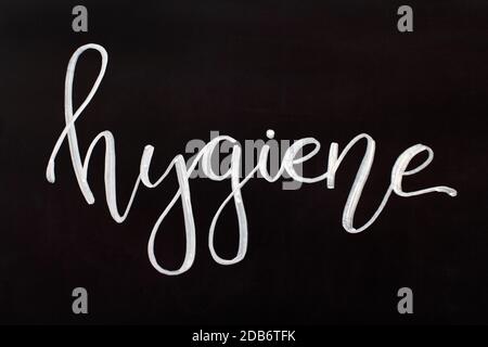 Chalk inscription HYGIENE on a black chalkboard. Handwritten lettering Stock Photo