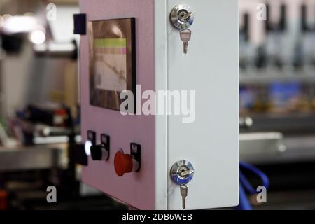 Steel pendant mounting HMI control panel enclosure with touch screen, switches, and keys. Control panel of a modern manufacturing line. Selective focu Stock Photo