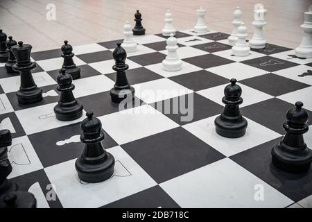 mannequins from chess game on black and white squares. Stock Photo