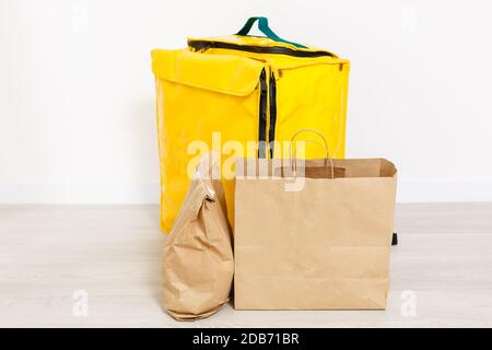 Courier with thermo bag on customer's house. Food delivery service Stock Photo