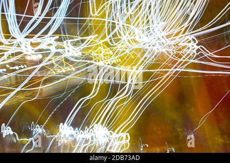 abstract background wavy light lines of arbitrary motion in defocus, light bokeh. Stock Photo