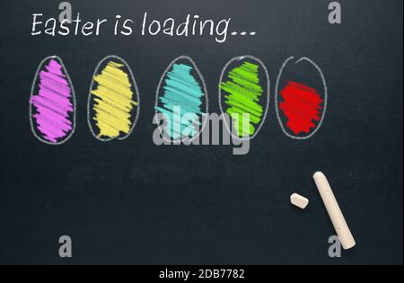 Hand drawn Easter eggs on a chalkboard with the words Easter is loading, Happy Easter background Stock Photo