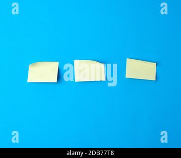 yellow paper stickers on a blue background, backdrop for the designer Stock Photo