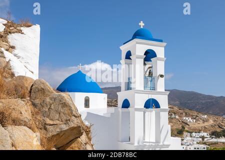 Chora, Ios Island, Greece- 20 September 2020: View of the Church of Virgin Mary of the Cliff. White building on the hill. Beautiful, sunny day. Stock Photo