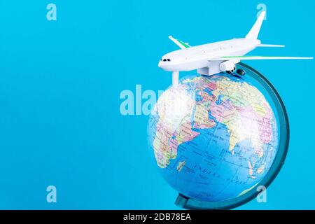 Plastic toy plane on the globe. Flight travel concept. Travel by airplane. Takeoff and landing of the aircraft. Return home from flight. empty Copy sp Stock Photo