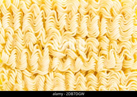 Instant noodles. Asian fast food on a yellow background close-up. Top views macro photography. Stock Photo