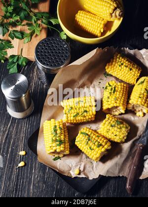 Corn on the cob with chopped parsley and spices. Stock Photo