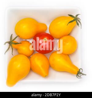 Red and yellow cherry tomatoes in a bowl in top view Stock Photo