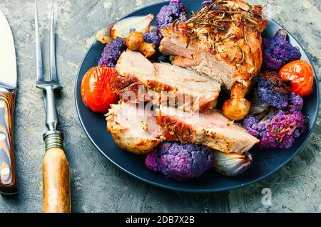 Italian pork porchetta with cauliflower.Traditional italian holiday food. Stock Photo