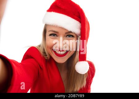 Cheerful woman in Christmas outfit taking a selfie Stock Photo