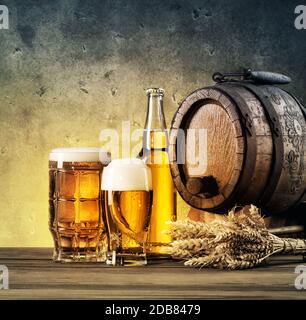 Barrel and beer glasses on the table tinted in yellow and blue Stock Photo