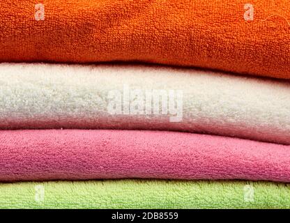 stack of colored cotton terry folded towels, close up Stock Photo