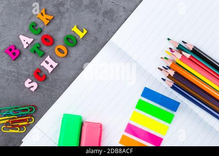 The layout of school supplies on a dark gray background. The view from the top. Back to school. Flat lay Stock Photo