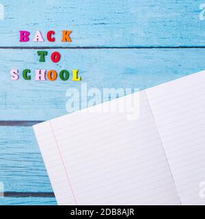 Layout of school supplies on a blue wooden background. The view from the top. Back to school. Flat lay Stock Photo