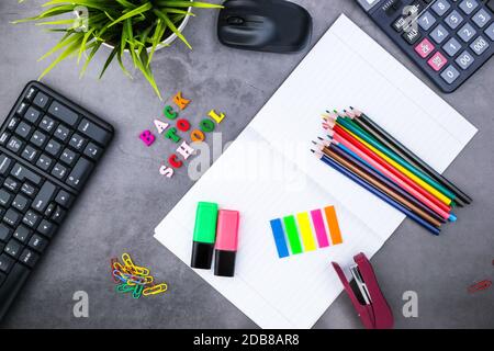 The layout of school supplies on a dark gray background. The view from the top. Back to school. Flat lay Stock Photo