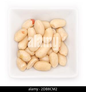Salted peanuts in a white bowl in top view Stock Photo