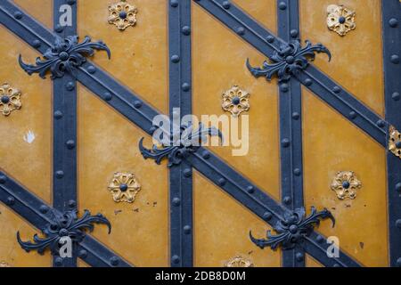 Old door with decoration wrought iron and ornaments as close-up Stock Photo