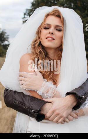 Man behind a bride with his arms around her, Russia Stock Photo