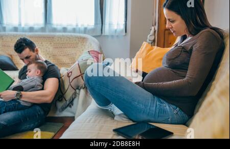 Family reading books in the living room Stock Photo