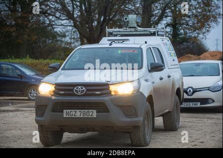 Aylesbury Vale, Buckinghamshire, UK. 16th November, 2020. The CCTV cameras on the top of an HS2 surveillance truck point towards a lone female photographer on a public footpath taking photos of a huge old oak tree destroyed by HS2. HS2 continue to regularly film members of the public and press near to their sites for 'profiling' purposes. Credit: Maureen McLean/Alamy Live News Stock Photo