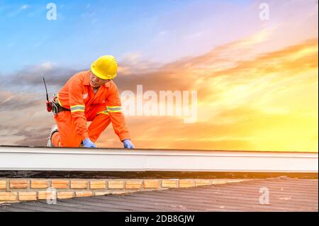 Construction worker working on a roof, Thailand Stock Photo