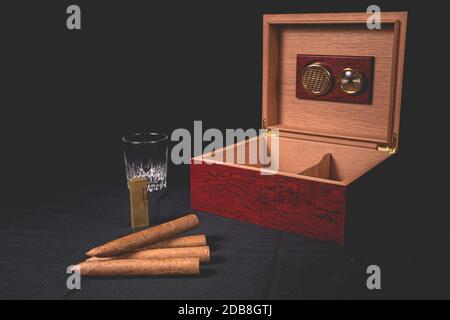 Cigar box on black background and gold lighter Stock Photo