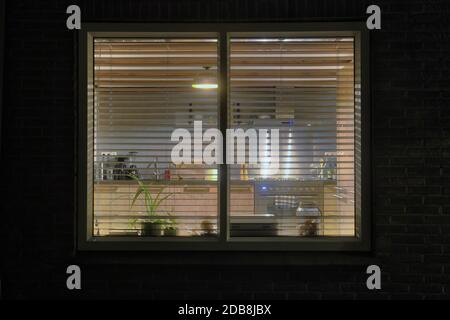 Cozy wooden kitchen, view from outside in the evening. modern retro interior design Stock Photo