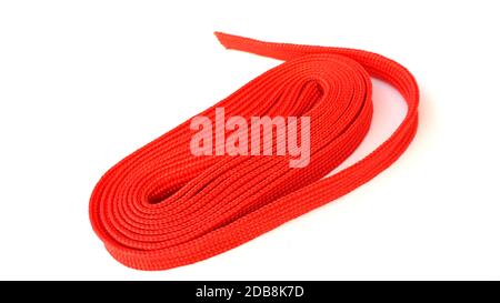 Red rope on white background. Fabric rope in red color folded in a coil. Stock Photo