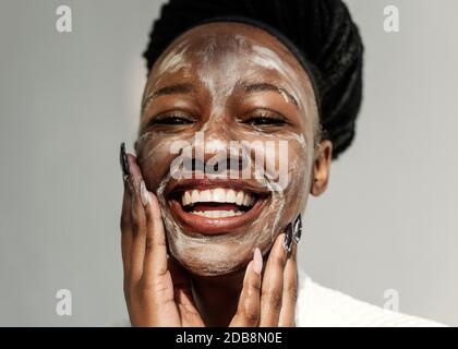 Portrait of a smiling woman with a face mask Stock Photo