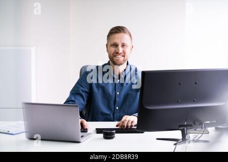 Man Working On Laptop Computer Doing Business Stock Photo