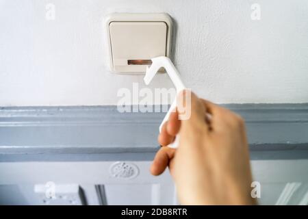 Man Using Contactless Tool To Press Button To Protect From Coronavirus Infection Stock Photo