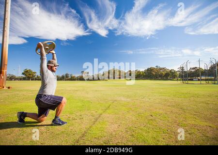 Man doing lunges with weights Stock Photo