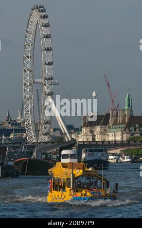 London Duck Tours on the River Thames carrying tourists in London. Behind is the London Eye.  DUKW,or Duck,is six-wheel-drive amphibious truck first m Stock Photo