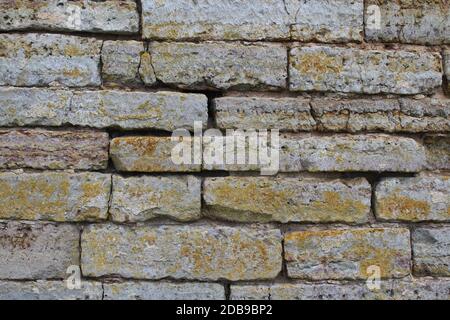 Destroyed by time and precipitation brick wall. The Background of old vintage brick wall Stock Photo