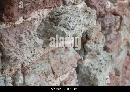 Destroyed by time and precipitation brick wall. The Background of old vintage brick wall Stock Photo