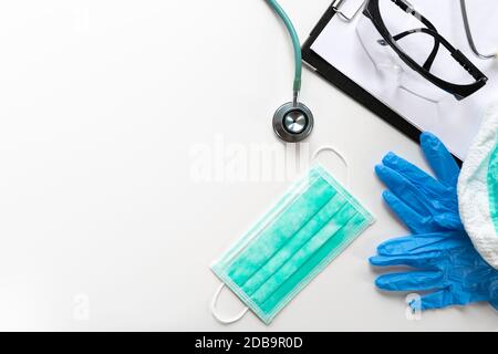 Doctors and nurses protection kit on a white table, top view Stock Photo
