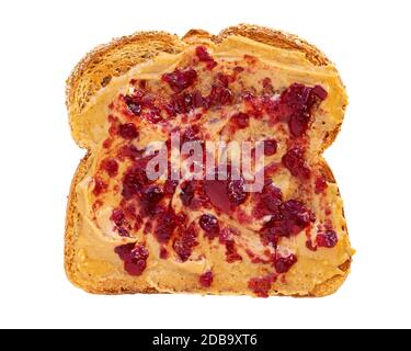 Creamy peanut butter spread with fruit jam on healthy whole wheat toast bread, isolated on white background, photographed from above Stock Photo