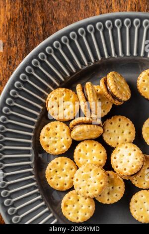 Mini cream sandwich cookies on plate. Top view. Stock Photo