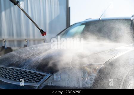 washing program at the self-service station. washing, rinsing and polishing of the car body under high pressure using treated water. Stock Photo