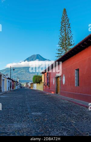 Street in Antigua city with Agua volcano, Guatemala. Stock Photo