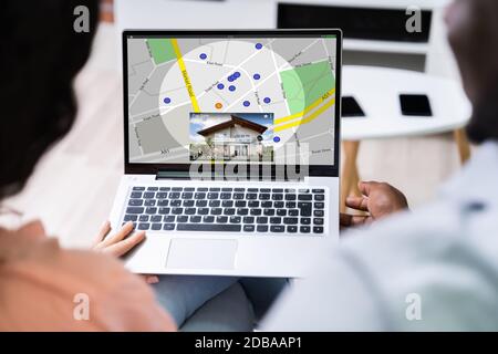 Close-up Of A Person Using GPS Map With Navigation Pointers On Laptop At Office Stock Photo