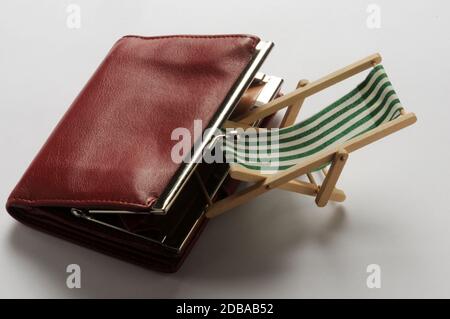Deck chair with purse on white background Stock Photo