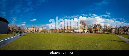 AMSTERDAM, NETHERLANDS - MARCH, 2018: People enjoying a sunny early spring day at  the famous Museum Square next to the National Museum in Amsterdam Stock Photo