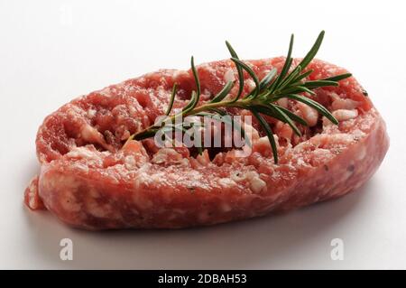 Raw sausage with rosemary on a white background Stock Photo