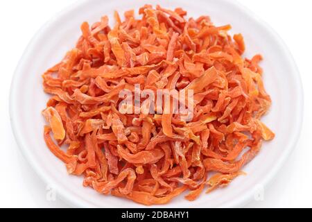 Dried chopped carrots in a bowl isolated on white background Stock Photo